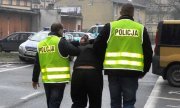 policjanci odprowadzają zatrzymanego mężczyznę