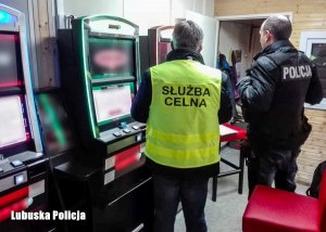 policjant i funkcjonariusz Krajowej Administracji Skarbowej przy nielegalnych automatach do gier