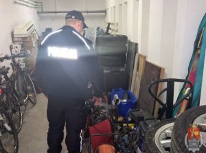 policjant podczas przeszukania garażu