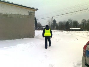 policjant w okolicy opuszczonego budynku