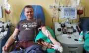 Starszy aspirant Krzysztof Heflich podczas oddawania krwi