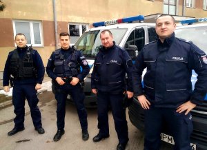 Policjanci z białostockiej „patrolówki” stoją przy radiowozie policyjnym