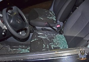 Wnętrze samochodu osobowego i rozbita szyba na siedzeniu kierowcy