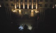 Nocne ujęcie z drona oświetlonego frontu budynku Komendy Głównej Policji