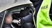 Policjant przeprowadza badanie na zawartość alkoholu w organizmie kierowcy