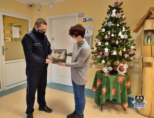 policjant przekazuje dary przedstawicielce hospicjum
