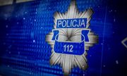 Policyjna gwiazda z napisem Policja i numerem 112 na niebieskim tle