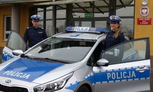 Umundurowani policjanci przy radiowozie i przed budynkiem KPP w Wieruszowie