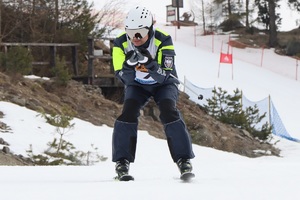Zdjęcie przedstawiające policjanta podczas zjazdu na nartach