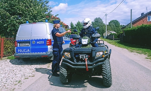 policjant na quadzie, obok stoi policjantka