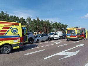 zderzenie czterech aut, widoczne karetki pogotowia ratunkowego, ratownicy medyczni oraz strażacy udzielający pomocy