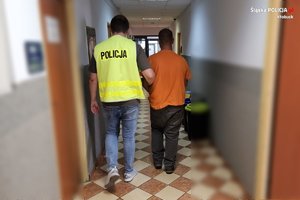 Policjant prowadzi zatrzymanego