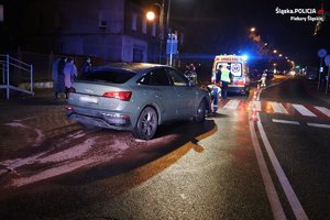 auto stoi tyłem do obiektywu na nocnej ulicy.