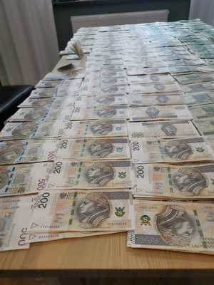 Banknoty 200-złotowe leżą na blacie.