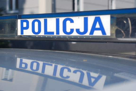 Napis Policja znajdujący się  na belce na dachu radiowozu.