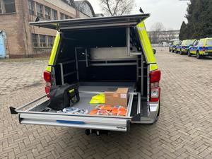 Zdjęcie przedstawia przestrzeń ładunkową radiowozu oznakowanego typu pick-up Isuzu D-MAX