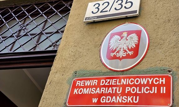 Na budynku przy ulicy Piwnej widoczny jest numer na murze i pod spodem tablica z napisem: Rewir Dzielnicowych Komisariatu Policji II w Gdańsku.