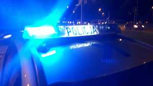 Pora wieczorna. Włączone sygnały na dachu radiowozu policyjnego.