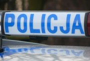 Napis Policja na belce na dachu radiowozu.