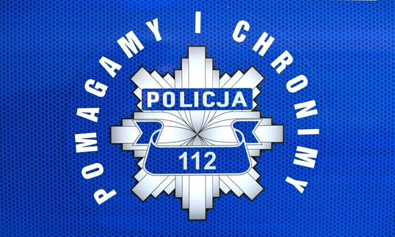 Policyjna gwiazda z napisem pomagamy i chronimy.