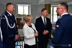 Policjanci i zaproszeni goście podczas oglądania wystawy w holu Komendy Wojewódzkiej Policji w Rzeszowie.