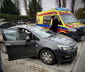 Samochód osobowy stoi obok karetki pogotowia.
