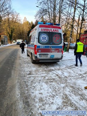 Policjanci przy ambulansie pogotowia ratunkowego.