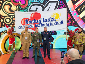 Zastępca komendanta głównego Policji razem z zastępcą komendanta głównego Straży Granicznej i zastępcą komendanta Głównego Straży Pożarnej studiu Finału WOŚP.