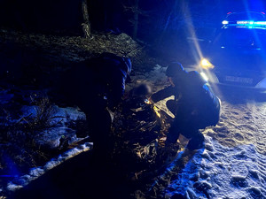 Policjanci przy uratowanej kobiecie.