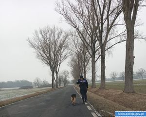 Policjantka prowadzi psa.