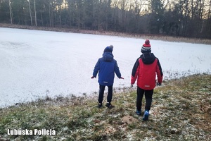 dzieci nad wodą. Stoją nad zamarzniętym jeziorem.