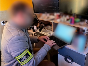 Funkcjonariusz CBZC siedzi przy stanowisku komputerowym.