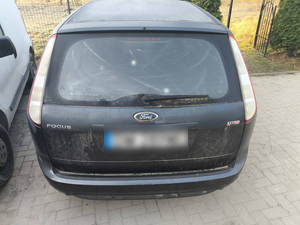 Policjanci prowadzą zatrzymanych. Kable porozkładane na ziemi w pudełkach i kartonach.