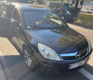 Auto, którym jechało osiem osób stoi na ulicy.