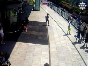 Na zdjęciu grupa młodych ludzi przed centrum handlowym.