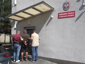 Policjanci prowadzą zatrzymanego.