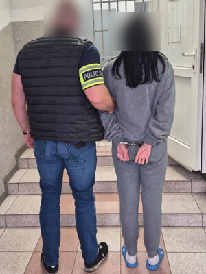 Policjant zatrzymuje kobietę.