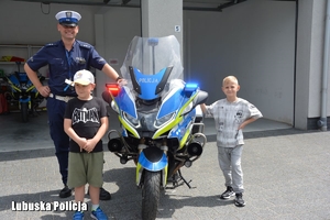 dzieci i policjant przy motocyklu