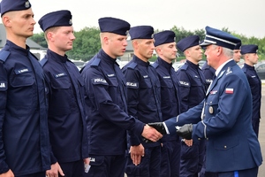 Komendant Wojewódzki Policji w Rzeszowie wręcza policyjne odznaki nowym funkcjonariuszom.