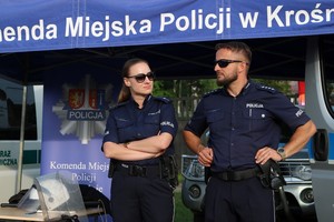 Policjanci podczas festyny podczas prezentacji wyposażenia na stoisku ekspozycyjnym