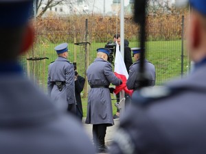 Policjanci przygotowują flagę Polski do wciągnięcia na maszt
