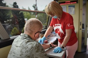 Pracowincy w mobilnym punkcie poboru krwi podczas pracy