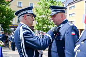 kolorowe zdjęcie przedstawiające Generała Wojewódzkiej Policji w Katowicach wręczającego odznaczenie