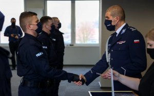 Komendant gratuluje młodemu policjantowi