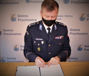 Komendant Wojewódzki Policji we Wrocławiu insp. Dariusz Wesołowski podpisuje akt notarialny.
