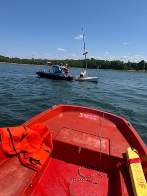na wodzie łódź policyjna na łodziach osoby w wodzie żaglówka